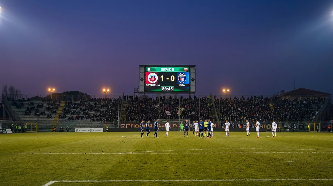 Tabellone luminoso dello stadio che mostra il punteggio di una partita di Serie B al tramonto
